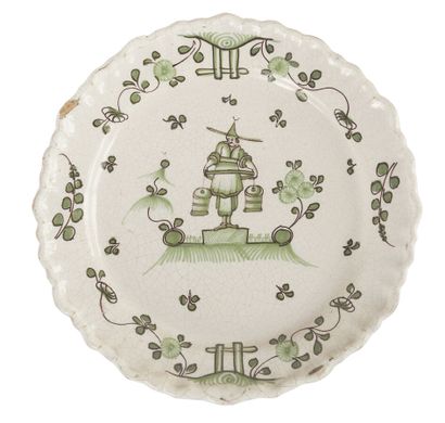 null BORDEAUX 
EARTHENWARE PLATE
decorated in green monochrome in the center of a...