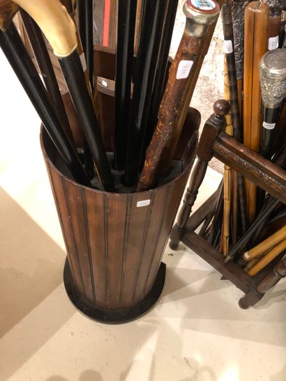 null A set of four display stands or cane holders: a half-circle wooden cane display...