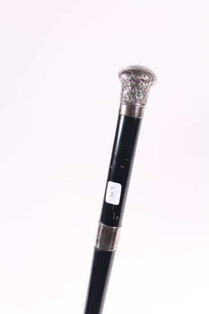 null Writer's cane, the shaft in black wood, set with two silver rings, the pommel...