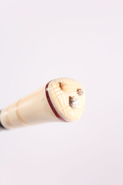 null Asian cane, the shaft in ebony, the pommel Milord in ivory decorated with three...