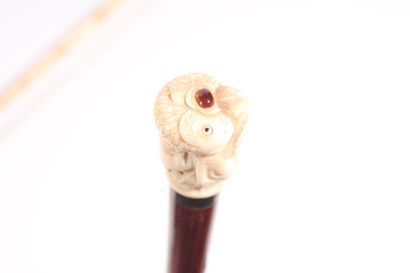 null Asian cane, exotic wood shaft, ivory pommel representing a fisherman holding...