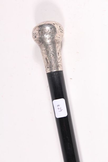 null English cane, the shaft in black wood, the knob in silver chased with flowers,...