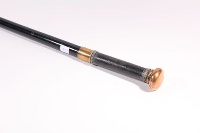 null Cane with system, the shaft out of black wooden, the flattened knob out of brass,...