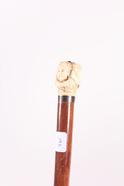 null Asian cane, exotic wood shaft, ivory pommel representing a fisherman holding...