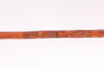 null Bamboo cane carved with an Asian landscape, signed Length 88,3 cm.