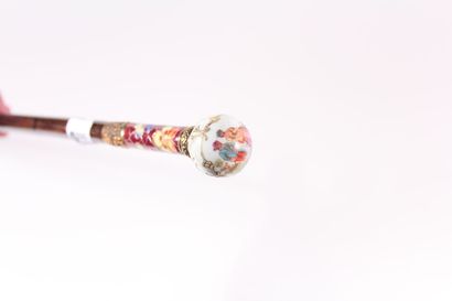 null Cane, bamboo shaft decorated with a brass ring then with enamelled floral decoration,...