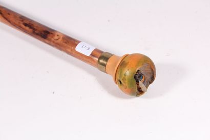 Cane, the round handle out of carved and...