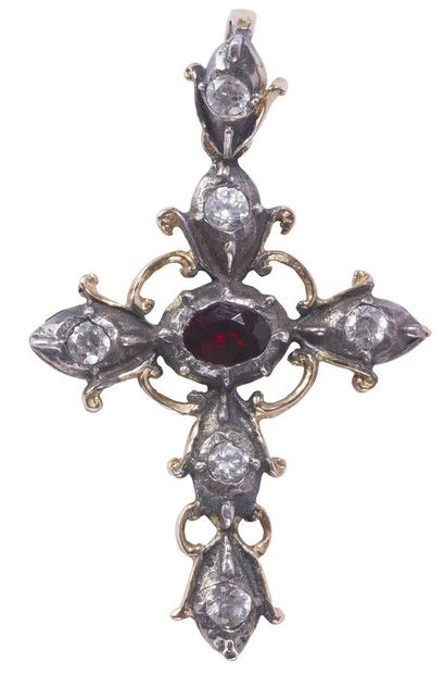 null A cross pendant in silver and vermeil set with white stones and a central garnet...