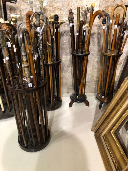 Seven round wooden cane stands. A turned...