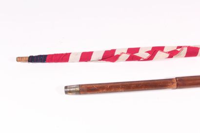 null American patriotic cane, the shaft in wood retracting a flag, the handle crook....