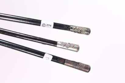 null Three canes in black painted wood, knob in silver plated metal decorated with...
