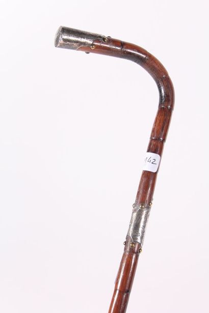 null Cane, the shaft ringed, the handle in square, ring and end of the pommel decorated...