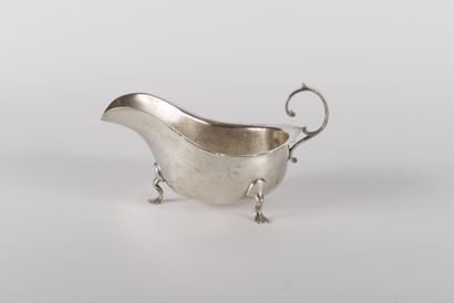 null A sauceboat in English silver, it rests on three feet moved the handle with...