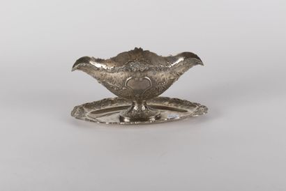 null Sauceboat and its dormant in silver with embossed and chased decoration of flowers,...