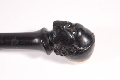 null Ebony monxyl cane, the pommel scuplted with a Moor's head, sulphur eyes, ivory...