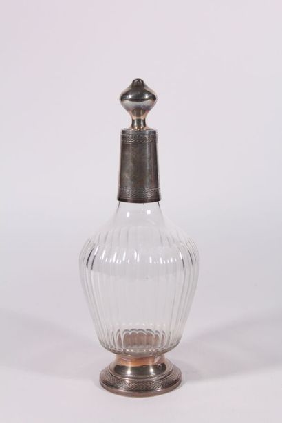 null Carafe and its stopper out of crystal, the body with grooves, the round base...