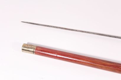 null Sword cane, the shaft in Malacca rush, set with two rings: one in brass and...