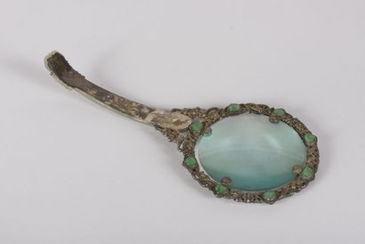 null Magnifying glass in silver plated metal and celadon jade
China, early 20th century
The...