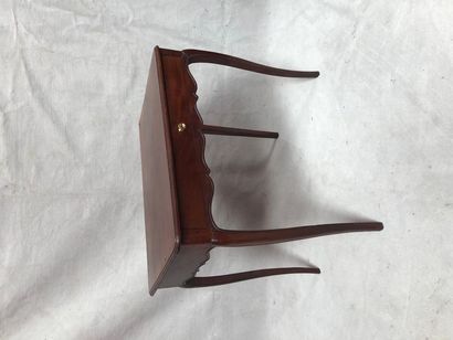 null Moulded mahogany table opening to a drawer on a belt and resting on four arched...