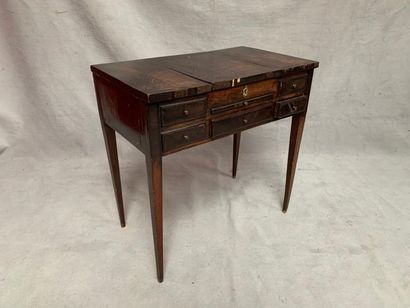 null Dark wood dressing table, opening with three flaps, two drawers and a pull-out....