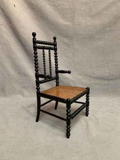 null Children's chair in blackened turned wood, caned seat.