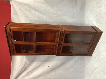 null Mahogany veneer showcase with two bodies each opening by two leaves. 19th century....