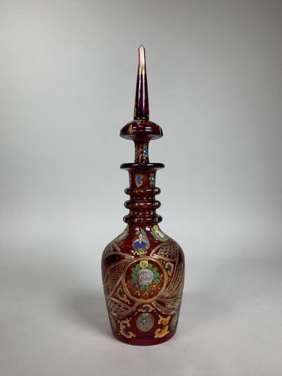  Carafe in transparent glass cut garnet and enamelled in polychrome and gilded with...