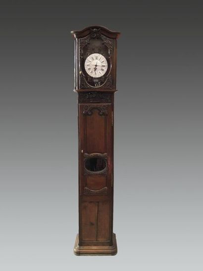 null Moulded and carved oak clock with scrolls and flower basket. The dial enamelled...