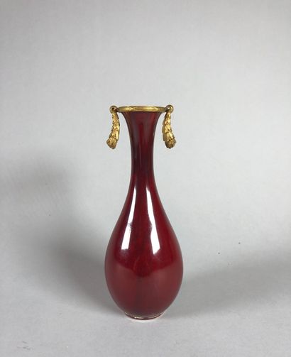 null SEVRES. Petit vase balustre en porcelaine sang de bœuf. Monture en bronze doré....