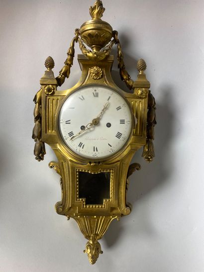 null Wall clock in gilt bronze surmounted by a fire pot, pine cones and a garland,...