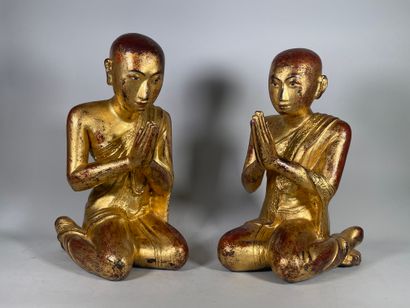 null Pair of gold-lacquered wooden subjects on a reddish-brown background, depicting...