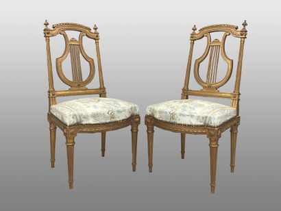 null Pair of chairs in molded wood, gilded and carved with rows of pearls and ribbons,...