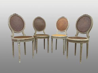 null Suite of four molded, carved and lacquered wood medallion chairs. Caned backs...