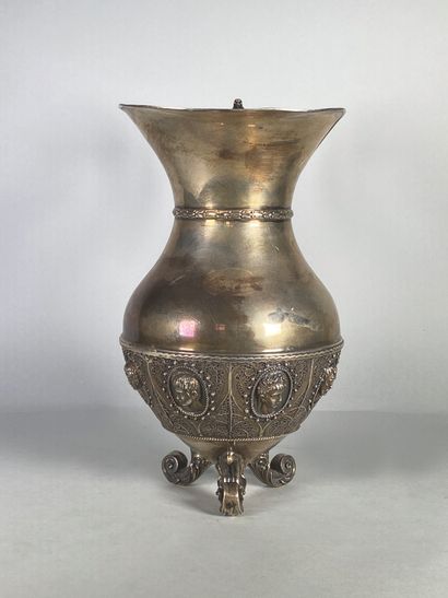 null Silver tripod pitcher (915°/°°), the body decorated with a frieze of six repoussé...
