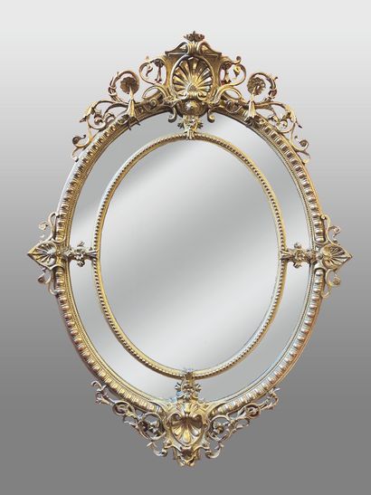 null Large oval mirror with glazing beads and pediment in wood and gilded stucco,...