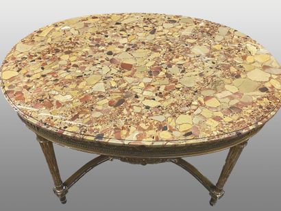 null Moulded, carved and gilded wood oval middle table resting on tapered and fluted...