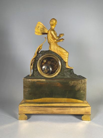 null Gilt bronze clock depicting Psyche on a rock. The circular dial with Roman numerals,...