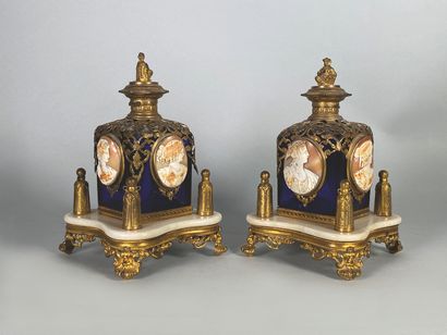 null A pair of blue-tinted glass perfume bottles, adorned with gilded metal mounts...