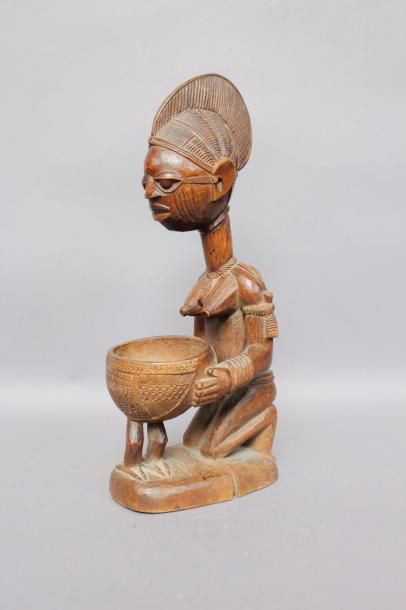 null Porteuse de coupe, Yoruba, Nigéria.
Bois sculpté à patine brune.
Haut.: 37,5...