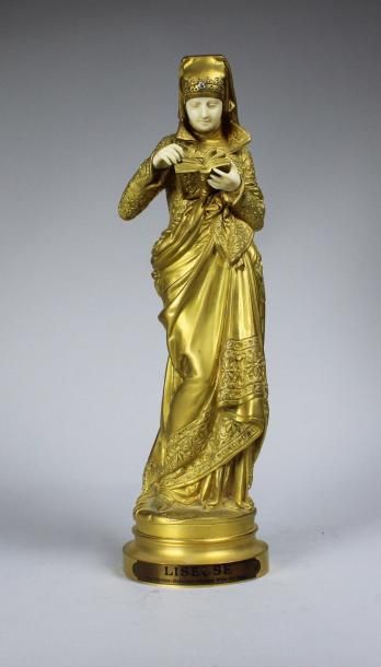 CARRIEr-BELLEUSE (1824-1887) 
La liseuse.
Epreuve en bronze doré et ivoire.
Signée...