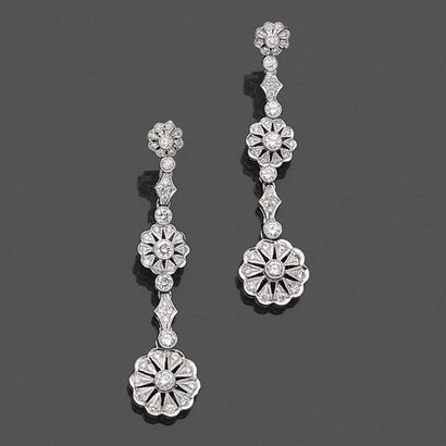 null Pair of "flower" EARRINGS in openwork white gold (750‰), paved with brilliant-cut...