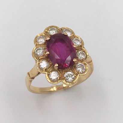 null Daisy" ring in yellow gold (750 thousandths) set with an oval ruby surrounded...