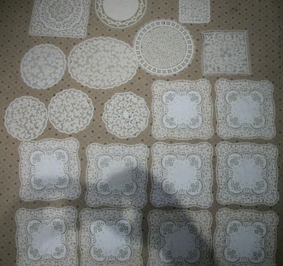 null Meeting of about twenty lace or lace-lined placemats.