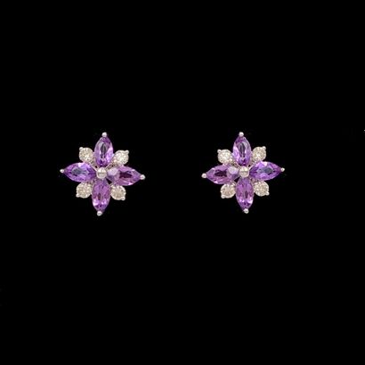 null Pair of white gold (750‰) "flower" EARRINGS set with four amethysts, alternated...