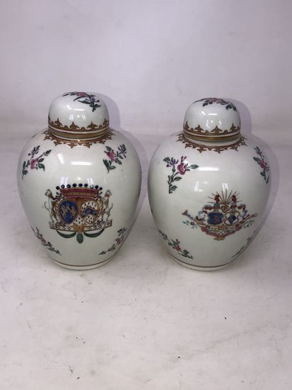 null Pair of porcelain covered pots with polychrome decoration of flowers, arms and...