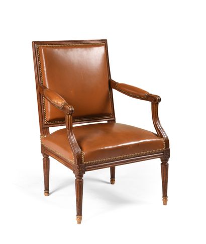 null An armchair with a flat rectangular back in patinated, moulded and carved wood,...