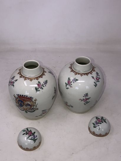 null Pair of porcelain covered pots with polychrome decoration of flowers, arms and...