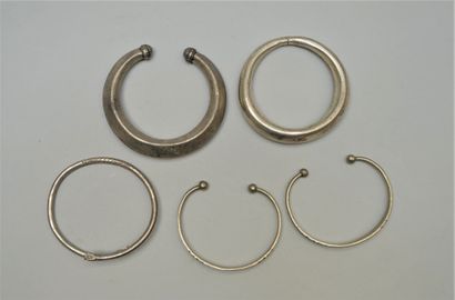 Set of three rigid open metal bracelets....