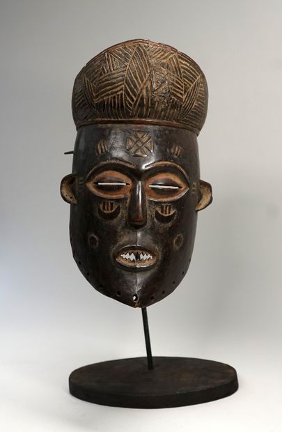 Patinated wooden mask in the style of Tshokwe...
