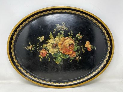null Oval sheet metal tray decorated with flowers on a black background, Modern work...